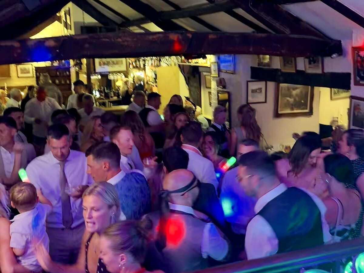 Wedding guests dancing at Fantails in Wetheral near Carlisle with colourful DJ lighting